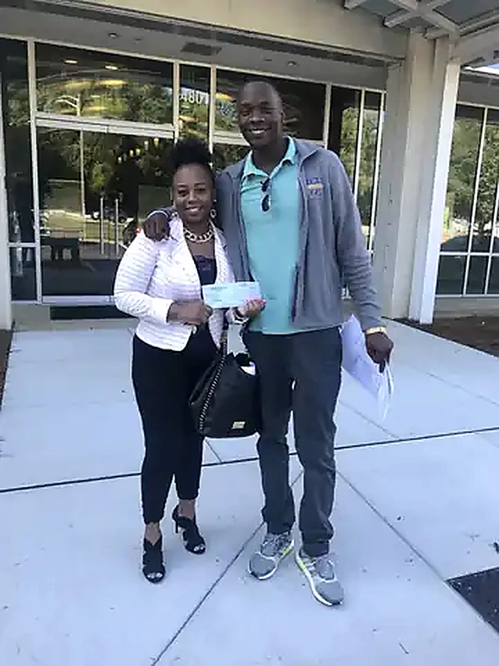 K Real Estate representative with a client after a local transaction